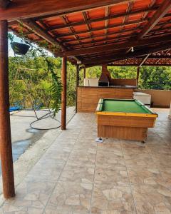 a pool table on a patio with a roof at Rancho Patrocínio in Patrocínio