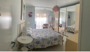 a bedroom with a bed with a table and a mirror at La Casa di Stella in Porto SantʼElpidio