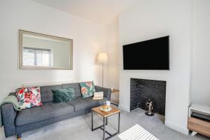 a living room with a couch and a fireplace at 3 Bed in Cardiff oc-bow188 in Cardiff