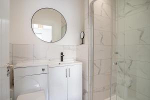 a bathroom with a mirror and a sink and a shower at 3 Bed in Cardiff oc-bow188 in Cardiff +17 photos