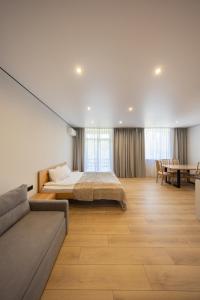 a large bedroom with a bed and a couch at MONTE GreeN in Polyana