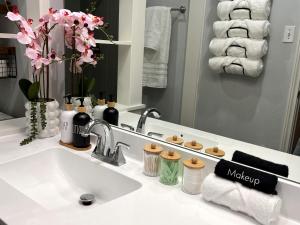 a bathroom counter with a sink and a mirror at Healing Haven King Bed Suite in Dallas +8 photos