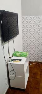 a tv sitting on top of a white dresser at Pousada Popular in Barreiras