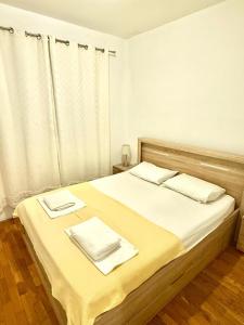 a bedroom with a bed with two towels on it at Riviera Budva Residence in Budva