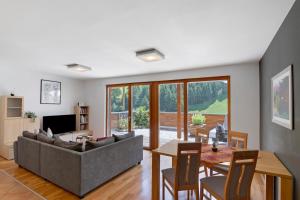 a living room with a couch and a table at Pritscheshof Ferienwohnung Terrasse in Malles Venosta