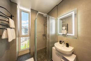 a bathroom with a sink and a shower and a mirror at MONTE GreeN in Polyana +92 photos