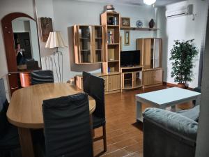 a living room with a table and a dining room at Chipiona CERCA DE LA PLAYA in Chipiona