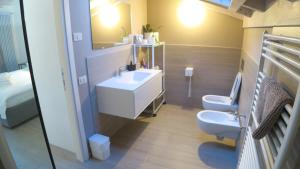 a bathroom with a sink and a toilet and a mirror at OnSuite With Wiew Near COMO in Erba