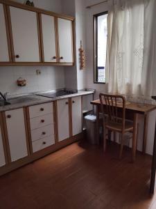a kitchen with a table and a table and a chair at Chipiona CERCA DE LA PLAYA in Chipiona