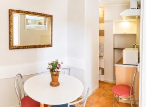 a white table with chairs and a vase of flowers at "Trakaitis" nameliai in Trakai +44 photos