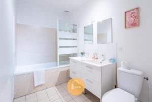 a bathroom with a toilet and a sink and a tub at Duplex Le G - Reine des neiges 10 min Disney Paris in Montévrain +29 photos