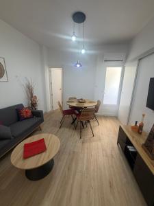 a living room with a couch and a table at Casa Boho in Puerto de Mazarrón