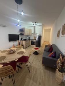a living room with a couch and a table with chairs at Casa Boho in Puerto de Mazarrón