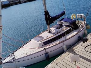 a boat is docked at a dock in the water at Miramare in Playa Blanca