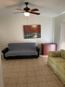 a living room with a couch and a ceiling fan at Dolphin Cove in Sarasota