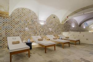 a room with four chairs and a wall with tiles at Casagrand Luxury Apartments Lisboa in Lisbon +27 photos