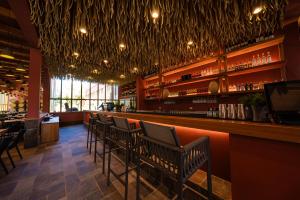 a bar with a row of chairs in a restaurant at Viscas Hotel Luxury Resort & Spa in Pariahuanca