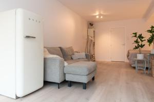 a living room with a couch and a chair at Studio Loet in Schagen