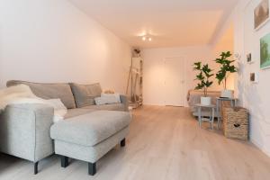 a living room with a couch and a chair at Studio Loet in Schagen