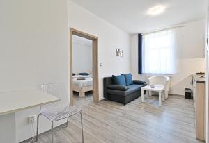 a living room with a couch and a mirror at Apartmán na výsluní in Luhačovice +8 photos