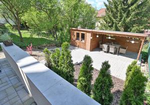 a backyard with a wooden cabin with a patio at Apartmán na výsluní in Luhačovice