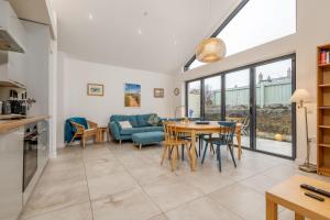 a kitchen and living room with a table and chairs at Tylosand, Allan Place No 8 in Earlsferry