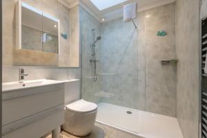 a bathroom with a shower and a toilet and a sink at Tylosand, Allan Place No 8 in Earlsferry +17 photos