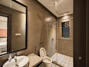 a bathroom with a shower and a toilet and a sink at The Bay Suites - Salt Lake in kolkata +55 photos