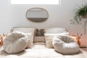 a bedroom with a bed with pillows and a mirror at Ben Thuis Studio Alkmaar in Alkmaar