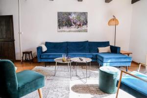 a living room with a blue couch and chairs at Maison Ainvelle - with Sauna in Ainvelle