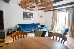 a living room with a blue couch and a table at Maison Ainvelle - with Sauna in Ainvelle