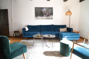 a living room with a blue couch and chairs at Maison Ainvelle - with Sauna in Ainvelle +31 photos