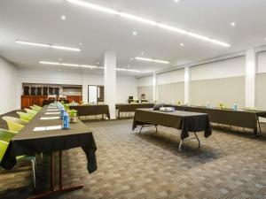 a large room with tables and chairs in a building at Ibis Styles Karratha in Karratha +66 photos
