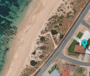 an aerial view of a beach with a house and the ocean at Absolute Beachfront Escape Family Retreat in Mandurah