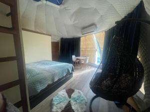 a bedroom with a bunk bed and a table with chairs at Private Dome Relax in Nature in San Bernardino