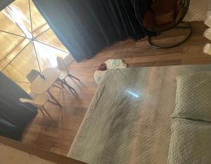 a room with a bed and two chairs on a wooden floor at Private Dome Relax in Nature in San Bernardino +4 photos