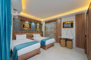 a hotel room with two beds and a bathroom at Aqua Fun Resort in Hurghada +65 photos