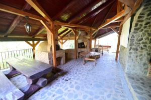 a large room with a wooden ceiling and a table at FLH - Casa Cascada in Fîntînele