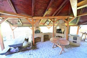a large room with a fireplace and a wooden ceiling at FLH - Casa Cascada in Fîntînele