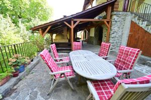 a group of red chairs and a table on a patio at FLH - Casa Cascada in Fîntînele