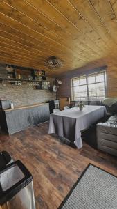 a room with a table and a couch and a fireplace at ''Ābeļdārzs'' in Jelgava