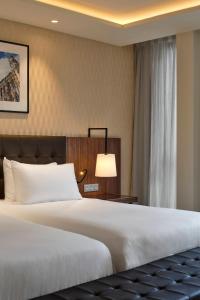 a hotel room with a bed and a lamp at Eurostars Avenue Louise in Brussels