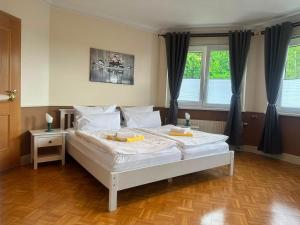 a bedroom with a white bed with two dishes on it at Hotel garni SEESCHLÖSSCHEN in Kölpinsee