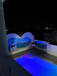 a plunge pool with a heart shaped bathtub at night at Djerba Moon in Djerba