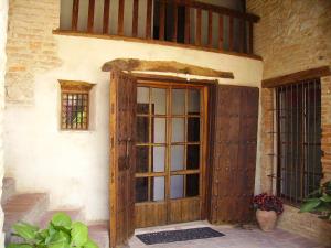 an entrance to a building with a wooden door at Hotel Boutique Condes Fúcares in Almadén