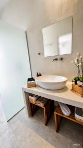 a bathroom with a sink and a mirror at Porto Paradiso Seaside Resort in Vromolimnos