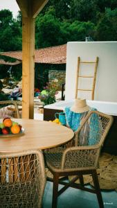 a table and chairs with a bowl of fruit on a patio at Porto Paradiso Seaside Resort in Vromolimnos