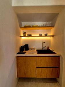 a kitchen with a sink and a counter top at Porto Paradiso Seaside Resort in Vromolimnos +19 photos