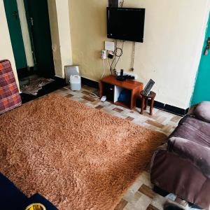a living room with a couch and a table at Shalompalace in Luanda