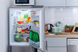 an open refrigerator filled with food and drinks at Chill apartments in Prague